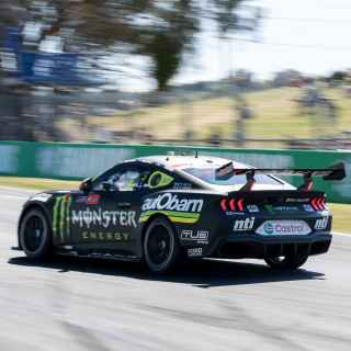 Ford mustang supercar racing down straight